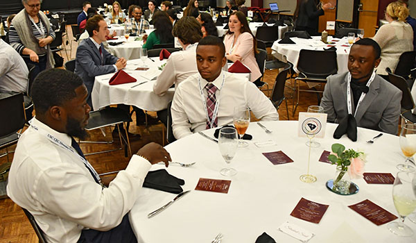 Three people conversing at a round table